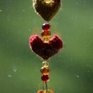Handmade heart glass beaded suncatcher with two wee hand-knit hearts