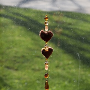 Handmade honey-colored crystal beaded suncatcher with two wee hand-knit hearts
