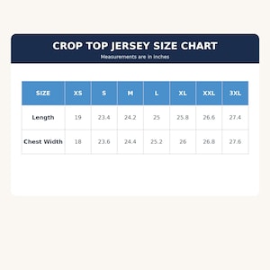 May include: A crop top jersey size chart with a dark blue header and white text. The table displays sizes from XS to 3XL with corresponding length and chest width measurements in inches, ranging from 18 to 27.6 inches for various garment sizes.