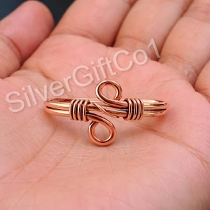 May include: A handmade wooden sign with the text "Welcome to our home" in a handwritten style. The sign is painted white with a distressed finish and a black border. A small, decorative heart is attached to the bottom.