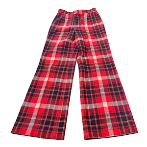 May include: Red, black, white, and yellow plaid pants. The pants have a wide leg and a high waist. The plaid pattern is a classic design, perfect for a vintage or retro look.