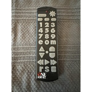 May include: Black remote control with white buttons. The remote has buttons for TV, VCR, and CBL. It also has number buttons and volume controls. The brand name "ONE FOR ALL" is printed at the bottom.