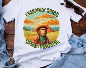 Camiseta unisex con estampado de Yeti y granjero al atardecer rústico, inspirada en la naturaleza.