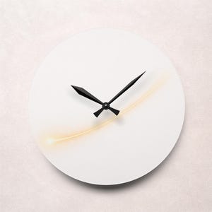 May include: A minimalist white wall clock with black hands. A thin, curved, yellow-gold line accents the face. The clock's design is simple and modern, suitable for various interior styles.