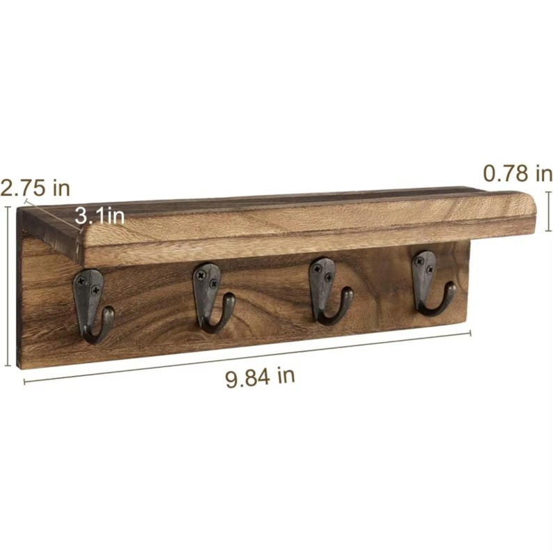May include: A rustic wooden key holder with four metal hooks. The shelf is 9.84 inches long, 3.1 inches wide, and 2.75 inches high. The key rack is made of dark brown wood and has a small shelf above the hooks.