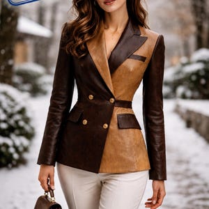 Woman wearing two tone brown leather blazer with double breasted gold buttons, tailored fit, luxury office style jacket