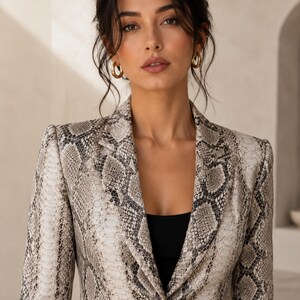 Elegant women’s snake print leather blazer featuring tailored fit, structured shoulders, python pattern, and luxury minimalist styling.