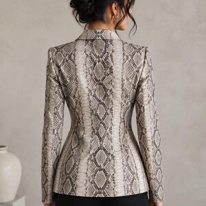 Back view of women’s python print leather blazer with fitted waist, sleek tailoring, and sophisticated neutral snake texture.