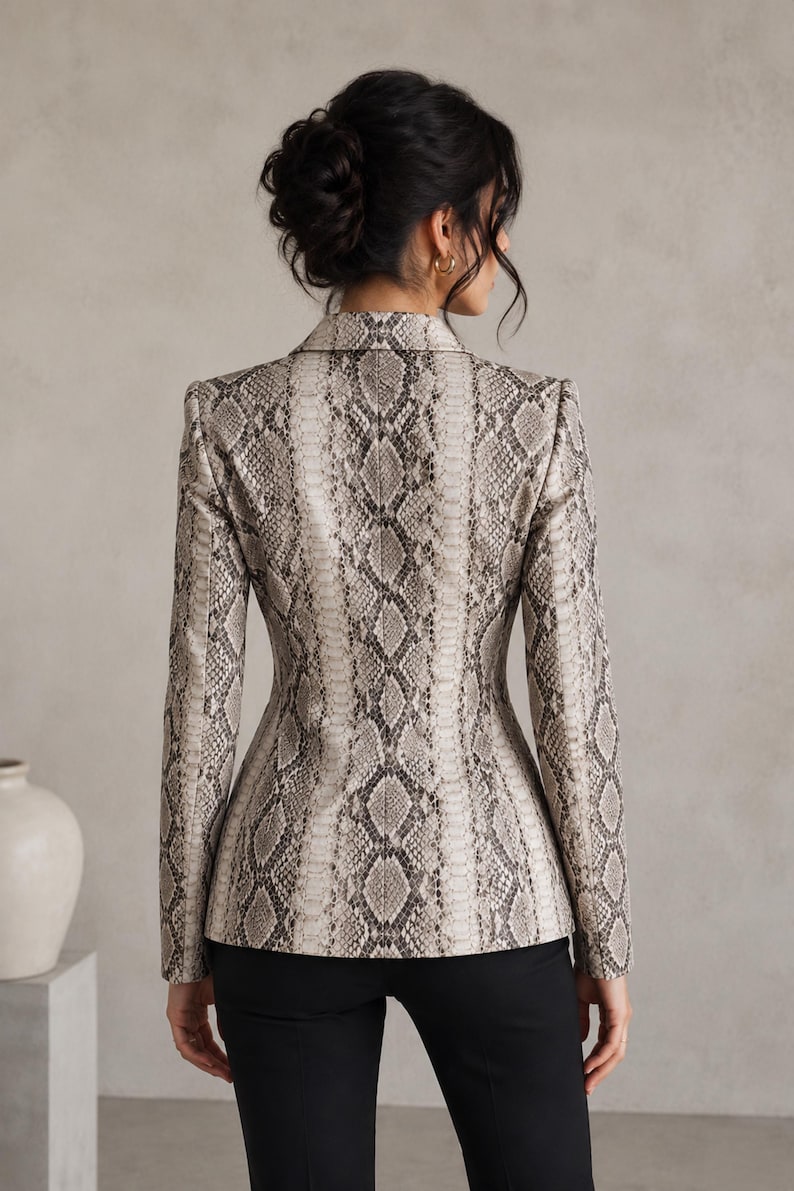 Back view of women’s python print leather blazer with fitted waist, sleek tailoring, and sophisticated neutral snake texture.