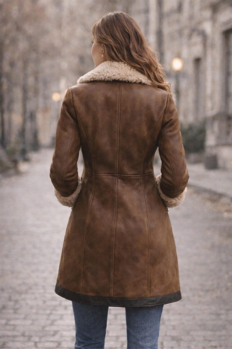 Back view of women’s brown shearling long coat with tailored fit and faux fur collar winter outerwear