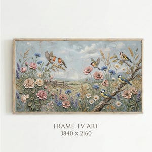Puede incluir: Una obra de arte enmarcada que presenta un relieve detallado de un prado floral con pájaros. La obra de arte muestra rosas rosas, acianos azules y otras flores silvestres. El marco es de color marrón claro, y el fondo es azul claro con una apariencia texturizada. El texto "FRAME TV ART" está en la parte inferior.
