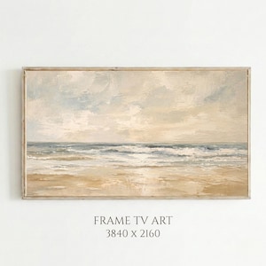Può includere: Dipinto di paesaggio incorniciato di una scena di spiaggia. L'opera raffigura una spiaggia sabbiosa, onde oceaniche e un cielo nuvoloso in tenui tonalità di beige, blu e grigio. La cornice è di colore legno chiaro. Il testo in basso recita "FRAME TV ART 3840 x 2160".