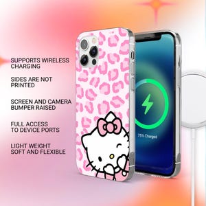 May include: A pink and white phone case featuring a leopard print pattern and a Hello Kitty graphic. The case is shown with a phone displaying a charging screen. Text on the case reads: Supports Wireless Charging, Sides Are Not Printed, Screen and Camera Bumper Raised, Full Access to Device Ports, Light Weight Soft and Flexible.