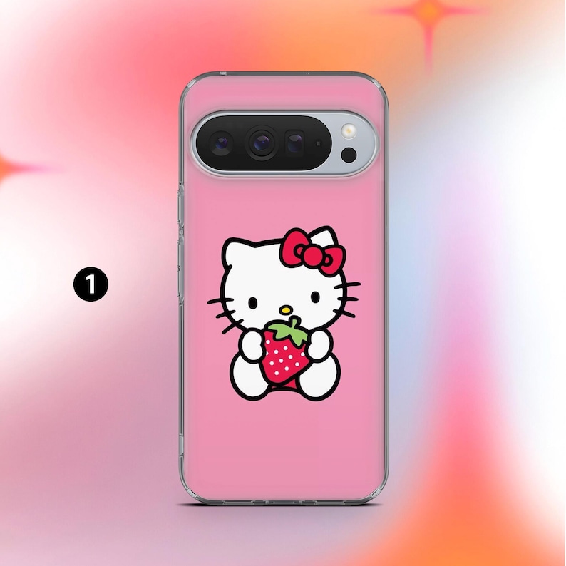 May include: A pink phone case featuring a cartoon image of Hello Kitty holding a strawberry. The case has a clear border and a camera cutout at the top. The Hello Kitty design includes a red bow and black whiskers.