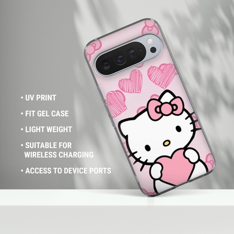 May include: A pink phone case featuring a Hello Kitty design with pink hearts. The case has a clear border and includes the text: UV PRINT, FIT GEL CASE, LIGHT WEIGHT, SUITABLE FOR WIRELESS CHARGING, and ACCESS TO DEVICE PORTS.