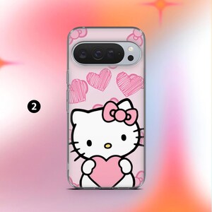 May include: A clear phone case featuring a Hello Kitty design. The case has a pink background with pink heart doodles. Hello Kitty is holding a pink heart. The phone case is designed to fit a specific phone model.