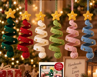 May include: Six spiral-shaped crochet Christmas tree ornaments in dark green, red, white, light green, pink, and blue. Each tree features a yellow crocheted star topper with a small white bead center and gold beads along the spiral. A tablet displays a video tutorial.
