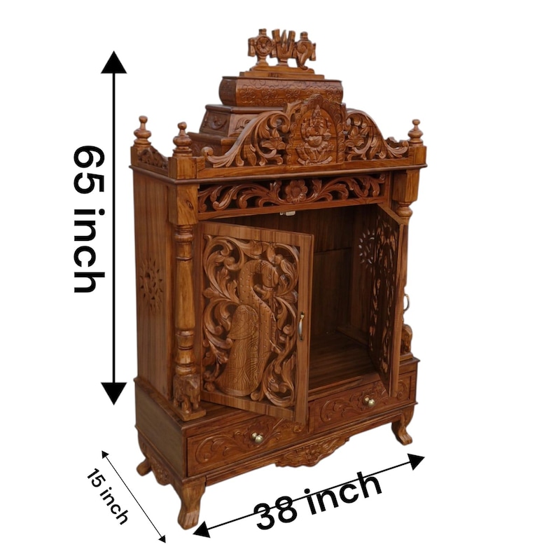 May include: A brown wooden temple cabinet featuring intricate carvings, two open doors with peacock motifs, and a bottom drawer. The structure measures 65 inches in height, 38 inches in width, and 15 inches in depth, with a decorative top crest.