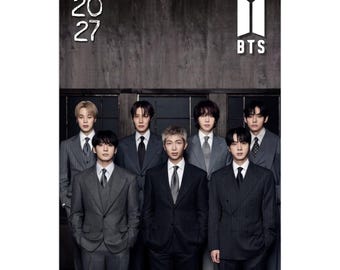May include: A 2027 wall calendar featuring a group portrait of seven individuals wearing formal suits. The top left corner displays the year 2027, and the top right corner features the white BTS logo. The background is a dark, textured wall.