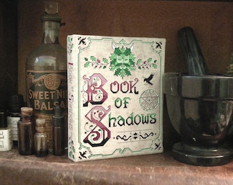 Pagan cross stitch patterns and Wiccan Book of Shadows book binding DIY tutorial with Green Man and Celtic knot work by The Elfin Forest