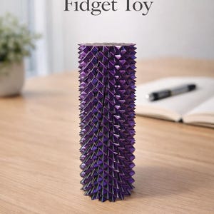 May include: A purple spiral fidget toy with a geometric design. The cylindrical toy is made of many small, triangular pieces. The words "Spiral Fidget Toy" and "STL File" are printed on the image.