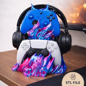May include: A 3D-printed headphone stand with a blue Xbox controller and a white PlayStation controller. The stand features a flame design in shades of blue, pink, and purple. The text "Headphone Stand" is at the top.