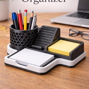May include: A black and white office organizer with a honeycomb pen holder, a phone stand, and a notepad holder. The organizer holds pens, pencils, and sticky notes. The text "Office Organizer" is at the top. The text "STL File" is at the bottom.