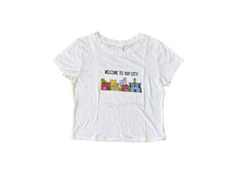 Camiseta gráfica "Bienvenido a Yap City" / Camiseta de bebé para mujer