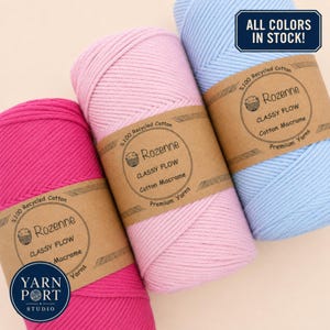 May include: Three spools of Rozenne Classy Flow cotton macrame cord in bright pink, light pink, and light blue. Each spool features a brown paper label with the text Rozenne Classy Flow Cotton Macrame Premium Yarns. A blue badge reads ALL COLORS IN STOCK.