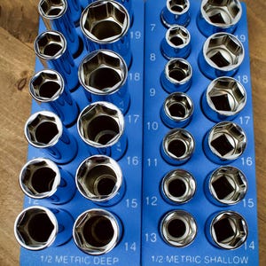 May include: A set of chrome sockets in a blue organizer. The sockets are arranged by size, with the sizes ranging from 7 to 19. The organizer is labeled "1/2 METRIC DEEP" and "1/2 METRIC SHALLOW".