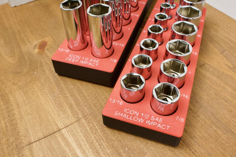 May include: Two red socket organizers with chrome sockets. One is labeled "ICON 1/2 SAE DEEP IMPACT" and the other "ICON 1/2 SAE SHALLOW IMPACT". The sockets are arranged in rows and are various sizes, including 13/16 and 7/8 inch.