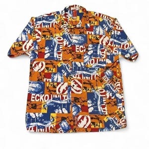 May include: A short-sleeve button-down shirt featuring an all-over graphic print in orange, blue, and red. The pattern consists of repeating rectangular blocks containing illustrations of boxers in a ring and the text ECKO UNLTD in white lettering.