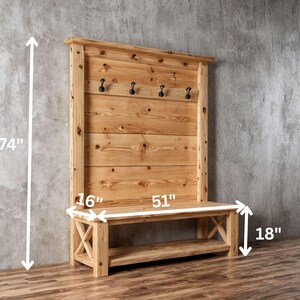 May include: A wooden entryway bench and coat rack combination. The bench is 130 cm wide, 46 cm high, and 41 cm deep. The coat rack is 188 cm tall and features five black hooks. The wood has a natural finish.