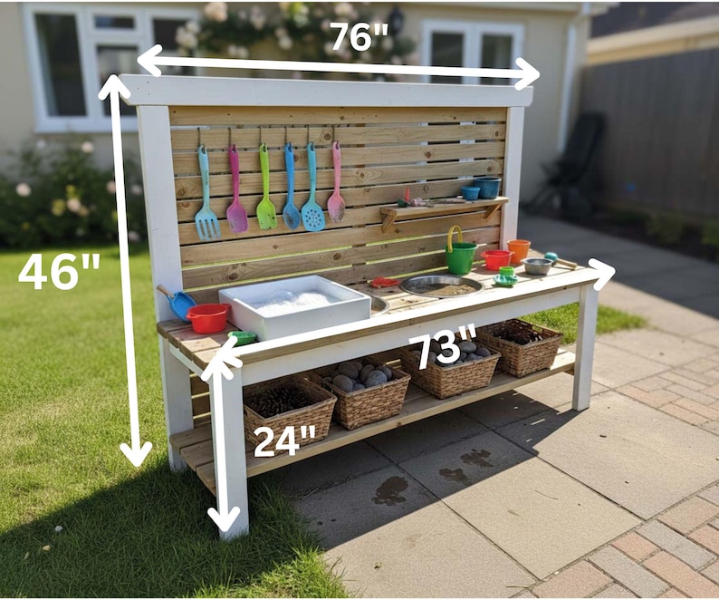 May include: A wooden outdoor play kitchen, 76 inches wide and 46 inches tall, with a white frame and natural wood accents. It features a sink, a cooking area, and hanging utensils. Includes a lower shelf with three wicker baskets, and is 24 inches deep.