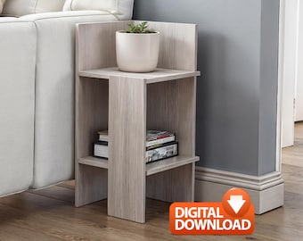 May include: A light wood-grain side table with two shelves. A white ceramic pot with a small plant sits on the top shelf. Books and magazines are on the lower shelf. The table is next to a white sofa.