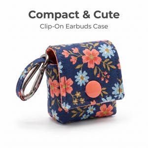 May include: A navy blue fabric earbuds case with a floral pattern of pink and light blue flowers, featuring a coral-colored snap button closure and a matching fabric loop with a silver metal carabiner. Text reads: Compact & Cute Clip-On Earbuds Case.