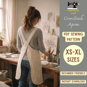 May include: A beige cross-back apron is worn by a person in a studio setting. The apron is made of a light-colored fabric and has a simple design. The image includes text that reads "CrossBack Apron", "PDF Sewing Pattern", and "XS-XL Sizes".