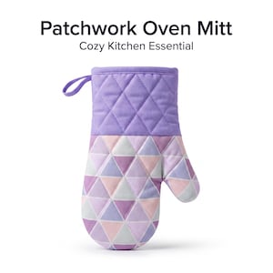 May include: A quilted oven mitt featuring a solid lavender upper section and a lower section with a geometric triangle pattern in shades of lavender, light pink, and grey. The mitt includes a small fabric loop for hanging and the text Patchwork Oven Mitt Cozy Kitchen Essential.