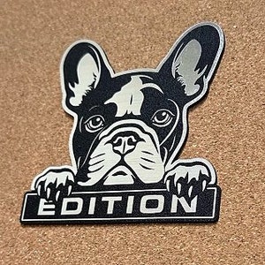 May include: Black and white illustration of a French bulldog peeking over a banner that says "EDITION".