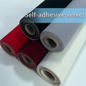 May include: Rolls of self-adhesive velvet in various colors, including red, black, gray, burgundy, and white. The rolls are tightly wound, showcasing the soft texture of the fabric. The text "Self-adhesive velvet" is displayed across the top of the image.