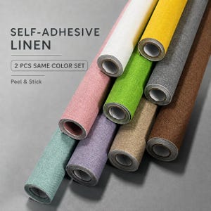 Puede incluir: Un conjunto de rollos de lino autoadhesivos en varios colores, incluyendo blanco, amarillo, gris, marrón, rosa, verde, morado y verde azulado. El texto dice SELF-ADHESIVE LINEN, 2 PCS SAME COLOR SET y Peel & Stick. Los rollos están dispuestos en diagonal.