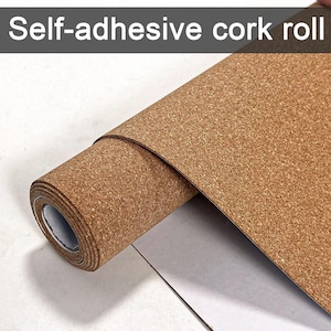 Pode incluir: Um rolo de material de cortiça autocolante. A cortiça é de cor castanha natural com uma superfície texturizada. O rolo está parcialmente desenrolado, revelando a espessura da cortiça e o papel de suporte branco. O texto "Self-adhesive cork roll" está no topo.
