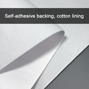 May include: Close-up of a sheet of white material with a self-adhesive backing and cotton lining. The material is partially peeled back, revealing a smooth, white interior. The text "Self-adhesive backing, cotton lining" is displayed at the top.
