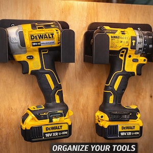 May include: Two yellow and black DeWalt 18V XR brushless power tools mounted on a wooden surface. The tools are secured in black holders. The text "ORGANIZE YOUR TOOLS" is at the bottom of the image.