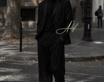 Traje de lino negro para hombre, corte holgado y pernera ancha.