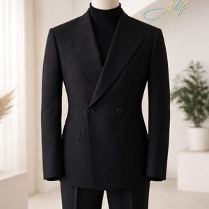 May include: A black double-breasted suit displayed on a mannequin. The suit features a notched lapel, two rows of buttons, and a matching black turtleneck. The suit is tailored and appears to be made of a smooth fabric. The background is a neutral color.