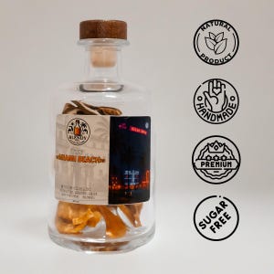 May include: A clear glass bottle with a wooden stopper, filled with dried fruit. The bottle has a label with the text "Miami Beach" and "Ocean Drive". The bottle is labeled as a natural, handmade, premium, and sugar-free product.