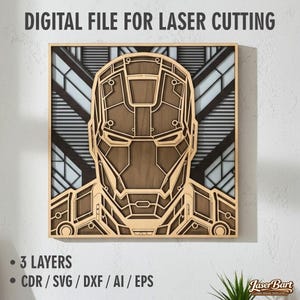 Könnte beinhalten: Ein mehrschichtiges Wandkunstwerk aus Holz mit einem detaillierten Design eines Superheldenhelms. Das Kunstwerk ist gerahmt und enthält den Text "DIGITAL FILE FOR LASER CUTTING". Zusätzlicher Text zeigt "3 LAYERS" und Dateiformate. Das Design ist in Braun- und Beigetönen gehalten.