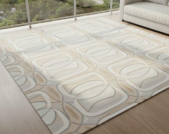May include: A rectangular area rug with a repeating abstract pattern in shades of beige, cream, and gray. The rug is placed on a wooden floor, with a balcony and a sofa in the background. The design features curved lines and geometric shapes.