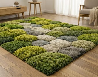 May include: A rectangular area rug with a textured, tufted design. The rug features a pattern of various shades of green, gray, and beige, resembling a field of moss or stepping stones. The rug is placed on a wooden floor.